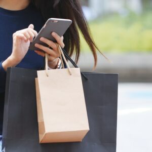 Woman using paper bags in support of reducing plastic waste for plastic free July